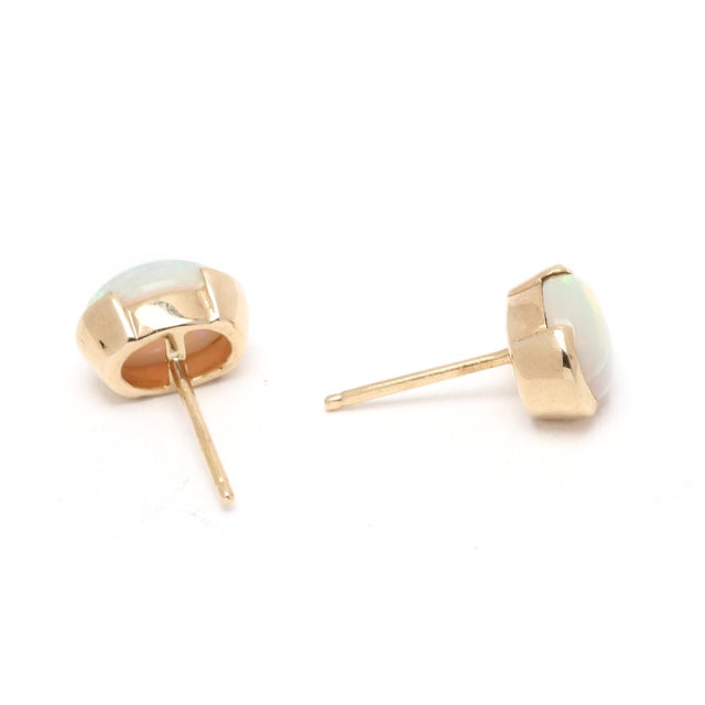 Stones: opal, 2 oval cab 7.6 x 6 mm Length: 9.2 mm Width: 6 mm Weight: 1.3 dwts. / 2 grams Stamps: "750" SKU: E4057 A...