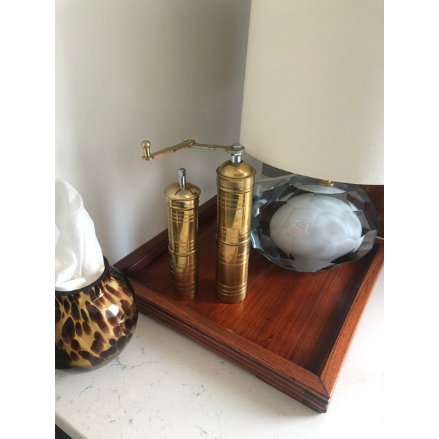 Beautiful vintage solid brass pepper grinders featuring a classic cylindrical design with decorative etched detailing....