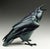 This bronze sculpture captures a raven in mid-caw, its form exuding a sense of vitality and presence. The smooth, dark...