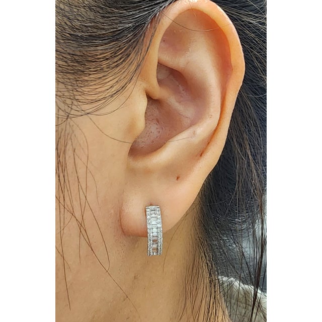 These gorgeous diamond huggies feature 0.50 ct of rounds and baguettes set in 14k white gold. The diamonds boast a color...