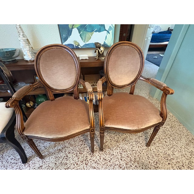 Beautiful pair of vintage Louis XVI-style fauteuil (open armchairs) in the classic French Provincial tradition. Imported...