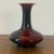 Antique Chinese bottle vase featuring a rich oxblood red glaze with deep tonal variation ranging from crimson to nearly...