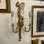 Ribbon and tassel brass finish metal wall sconce. It is traditional and has a lot of detail including the glass strands...