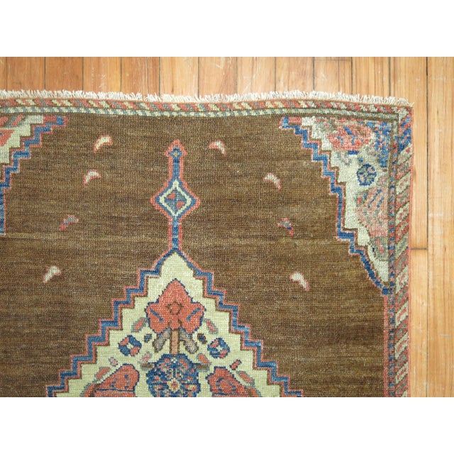 An early 20th century Persian Serab square size mat. Simple open design on a brown camel field. 2'4'' x 2'8''