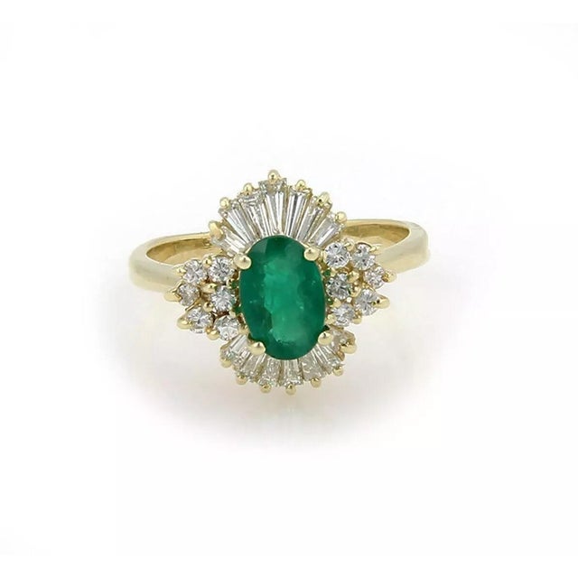 This lovely cocktail ring is crafted from 14k yellow gold featuring a fancy flare base with baguette and round cut...