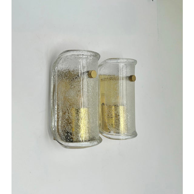 Wonderful high-end wall light fixture with brass details and thick textured blown glass. Manufactured in the 1960s, marked...