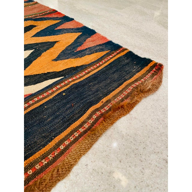 The pictured rug is a Qashqai kilim. These rugs are known for their bold designs, often handwoven by nomadic tribes in the...