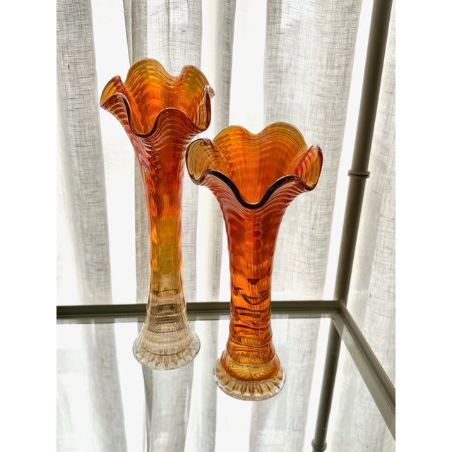Lovely pair of mid century swung vases. Carnival glass iridescent shine and color variations from deep tangerine orange to...