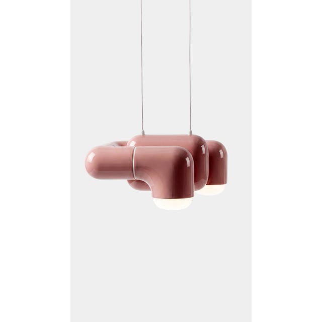 A pendant light with real character in a small footprint. Curved printed tiles interlock into a low, wide shade that seems...