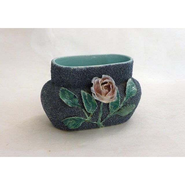 Small antique earthenware planter/vase: oblong, bulbous body/oval neck, with a large raised earthenware decoration of a...