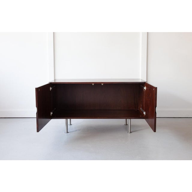 A lovely low cabinet in rosewood with attractive inset handles and chrome legs, ideally sized as a television stand. The...