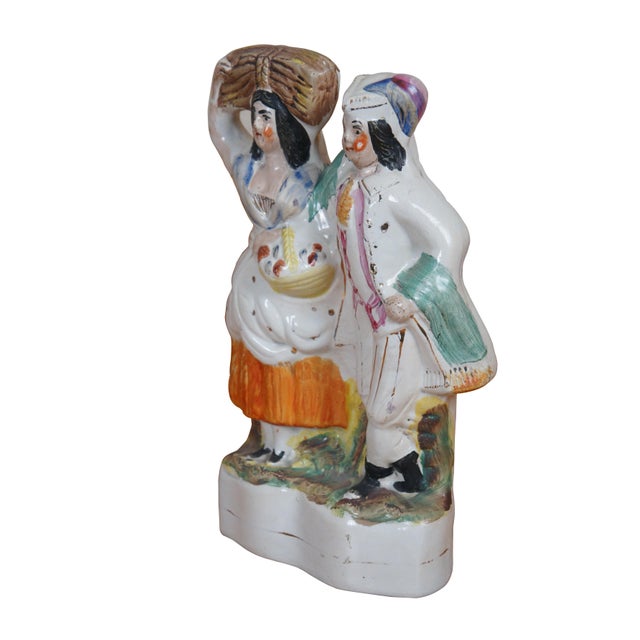 Antique 19th century Staffordshire porcelain flatback figurine depicting a couple of figures - a gentleman in fine...