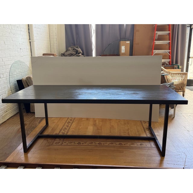 Design Plus Gallery presents a Bespoke Dining Table. This table pairs a wood top with an iron base, creating a balanced...