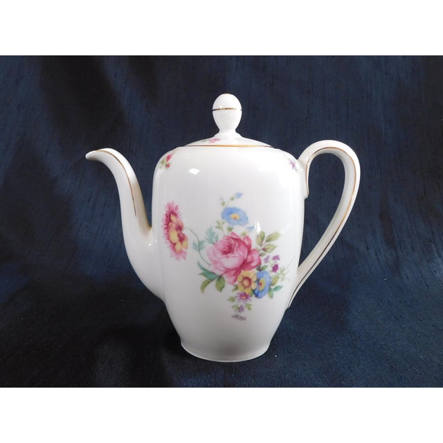 This is a white floral teapot by Johann Haviland in an unknown pattern. It is a smaller teapot. The teapot is white with...