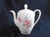 This is a white floral teapot by Johann Haviland in an unknown pattern. It is a smaller teapot. The teapot is white with...