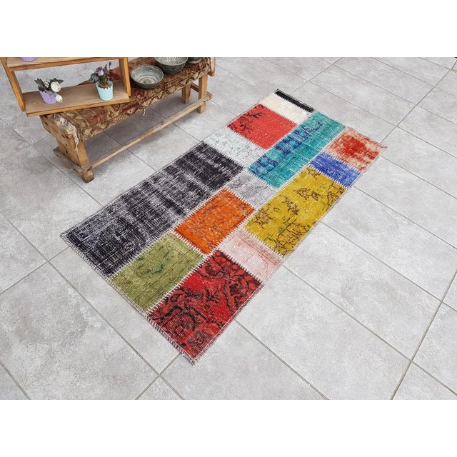 This is a vintage Turkish Oushak rug from the Mid 20th Century. The piece was hand-knotted.