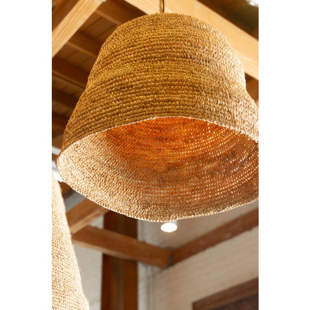 Defined by its generous 24-inch diameter and grounding dome profile, this oversized seagrass pendant serves as a...