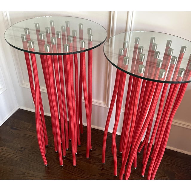 A pair of tall red ORG table designed by Fabio Novembre (Italian, born 1967) in 2001 for Cappellini. Made of glass top...