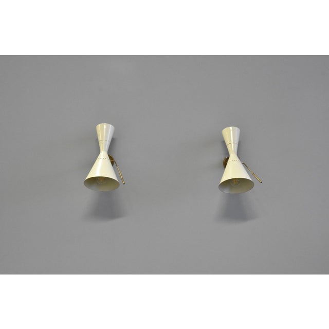 Stilnovo Italia wall lamp in painted aluminum and brass details, adjustable, with double light This piece has an...