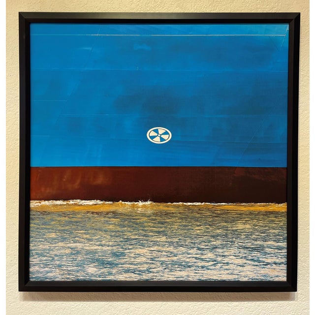 This artwork features a striking composition that emphasizes bold fields of blue, contrasting with a rich brown at the...