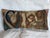This elongated decorative pillow is crafted from a tapestry fragment featuring a complex figural composition defined by...