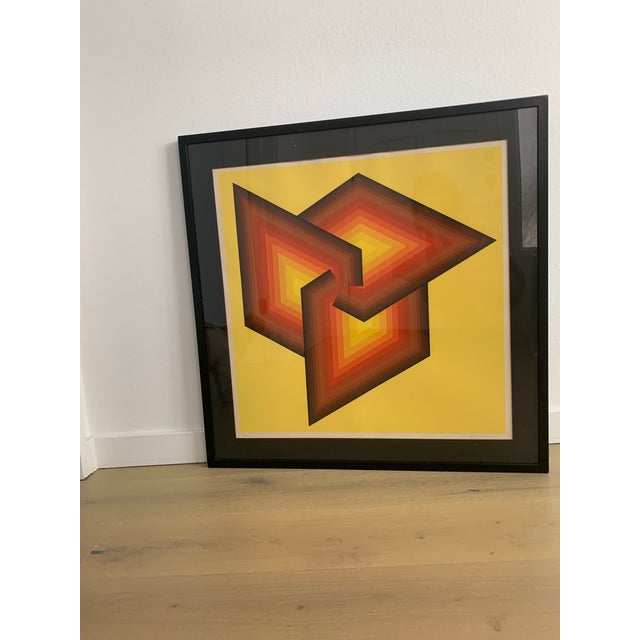 Striking geometric piece in vivid warm colors framed and matted in black. Signature is illegible. Numbered 184/250.