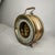 This brass barometer features a brass bezel and a dial with an open center section that reveals an exquisite gold-plated...