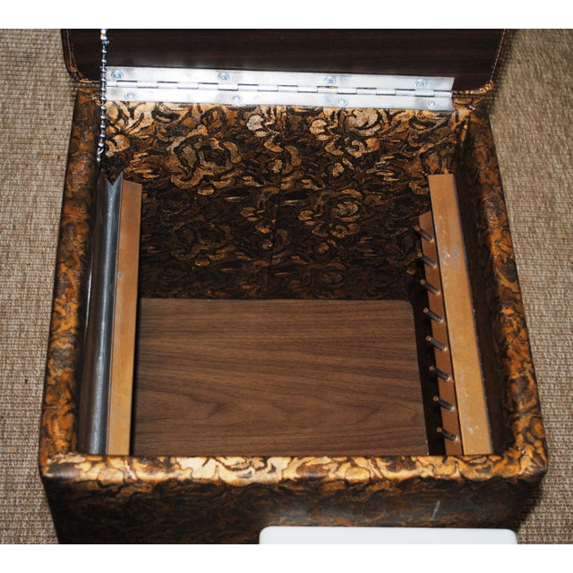 This is a mid-century sewing ottoman with storage. It combined function with style. The vinyl covering resembles a rich...