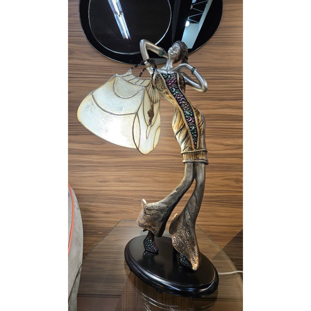 Artmax 8229-LM2 sculptural table lamp featuring a hand-painted resin and metal female figure with a Capiz shell shade. The...