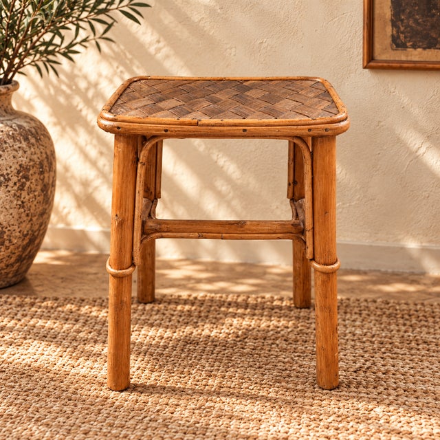 Beautiful pair of vintage bamboo stools, consisting of one taller stool and one low stool. Both pieces feature rounded...