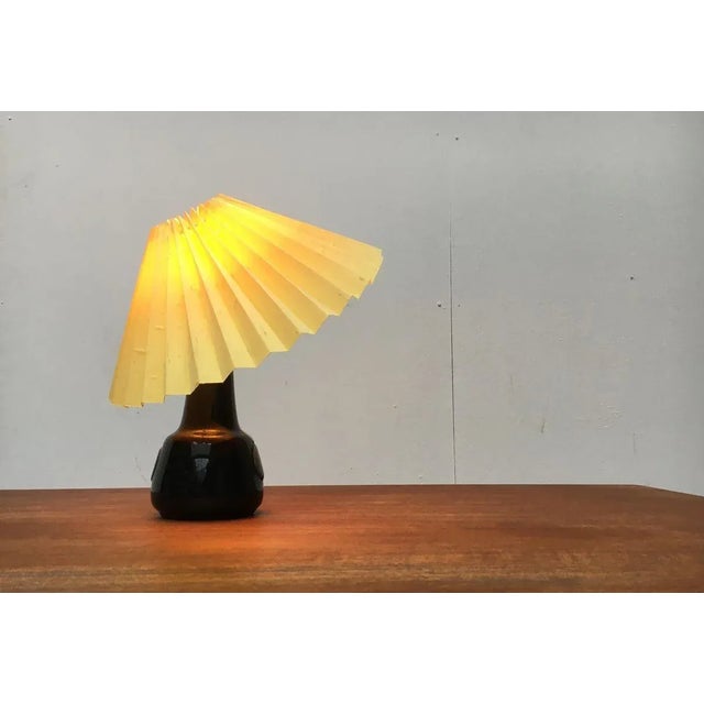 mall ceramic table lamp from the Danish manufacturer Søholm from the 60's. The conical pleated shade sits with a clamp...