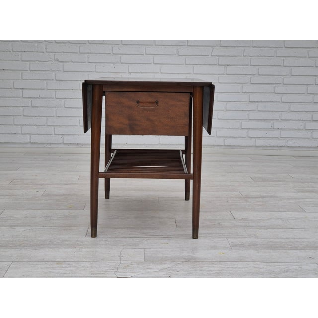 1950s, Danish foldable coffee table with drawer and shelf. Original good condition. Beech wood legs with brass plugs. Top...