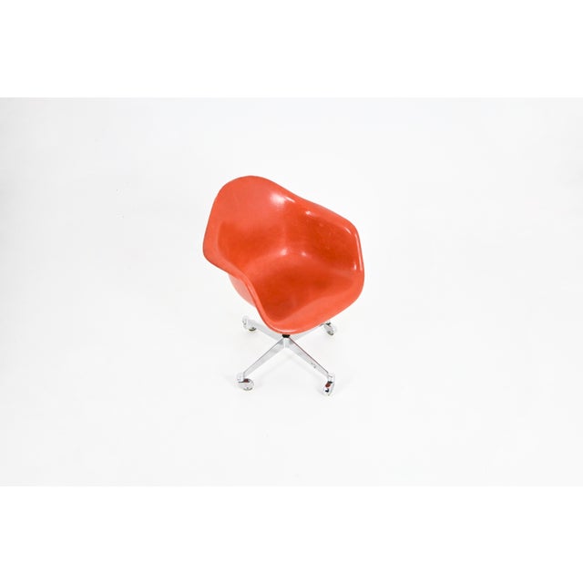 Swivel chair on casters, made of metal and fiberglass. Wear and tear consistent with age and time. This piece has an...