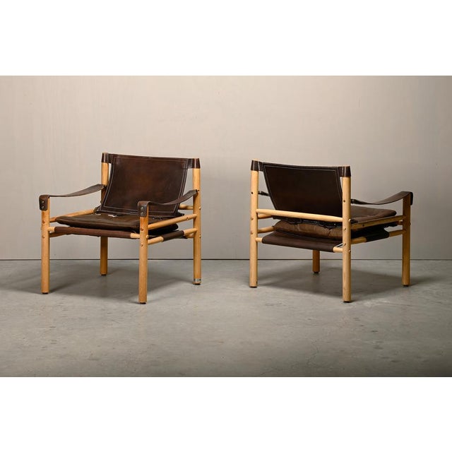 Nice pair of Sirocco Safari Lounge Chairs designed by Arne Norell and manufactured by Norell Möbel AB in Sweden. Solid Ash...