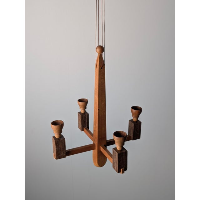Danish hanging candle chandelier executed in solid wood with a geometric Art Deco architectural composition. The structure...