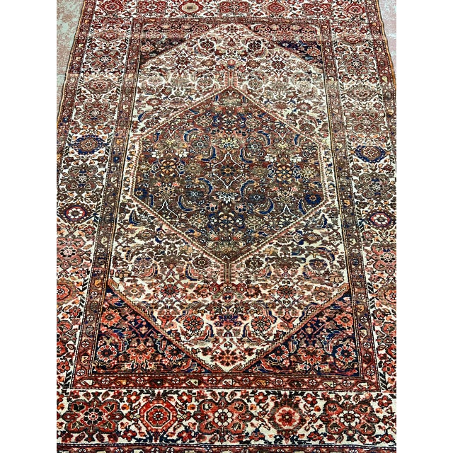 Antique Persian Malayer rug, hand-knotted in Iran from 100% wool. Measuring 4’4” x 6’5”, the rug features a traditional...