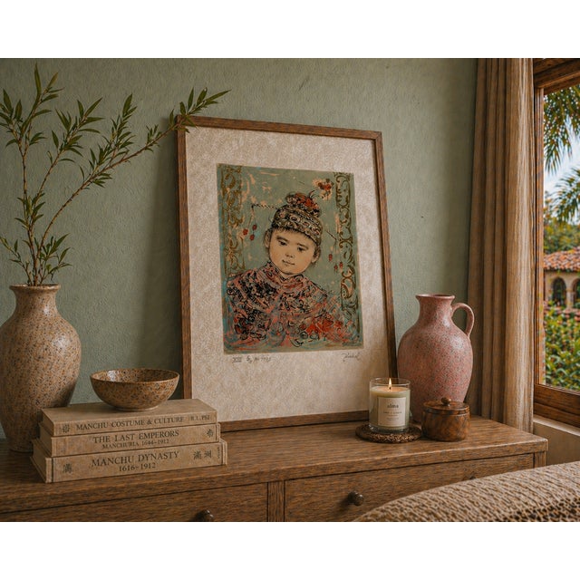 This piece features one of Hibel’s signature subjects—a delicately rendered child portrait, executed with soft tonal...