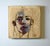Piercing Blues features a striking portrait characterized by a blend of soft and bold brushstrokes that convey depth and...