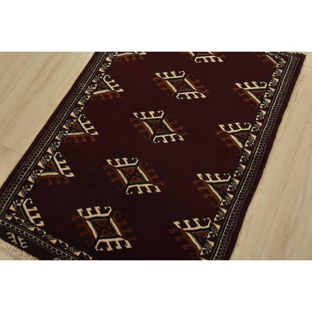 An authentic vintage tribal Turkmen rug hand-knotted with fine wool and natural dyes. This nomadic oriental rug features a...