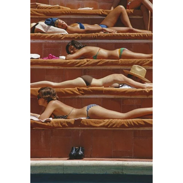 Sunbathing In Capri 1974 by Slim Aarons Slim Aarons Limited Estate Edition Sunbathers by a swimming pool in Capri, Italy,...