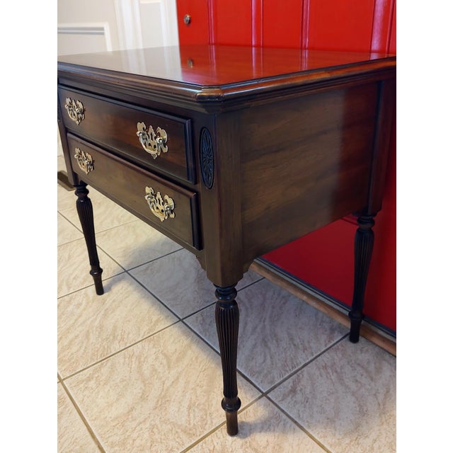 This lovely 1980's Ethan Allen nightstand has been finely crafted of solid cherry. It features two dovetail drawers,...
