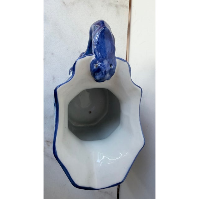 Add a striking touch of Grandmillennial charm to your decor with this gorgeous blue and white ceramic octagonal pitcher....
