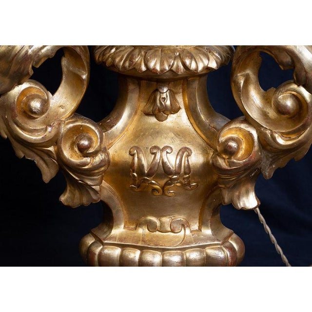 Pair of Neapolitan lamps in gilded and carved wood dating back to the mid-18th century. The central stem, shaped like an...