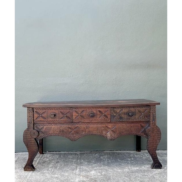 This remarkable vintage console table captures the rugged beauty of Spanish Colonial craftsmanship and folk art tradition....