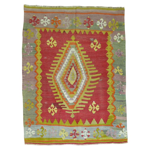 A one of a kind vintage Turkish Kilim with a traditional central medallion and border design. The field is a bright red,...