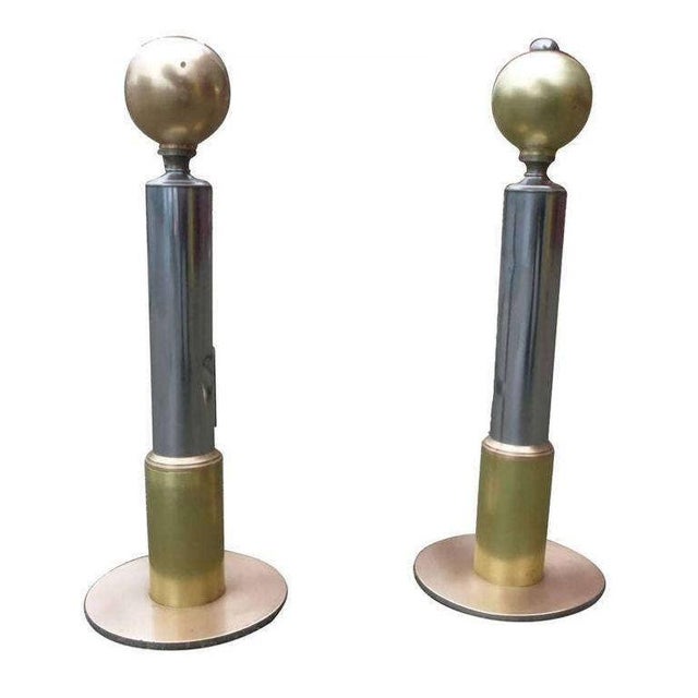 This American Art Deco chrome and brass andirons set of two which have been restored to its original shine. The andirons...
