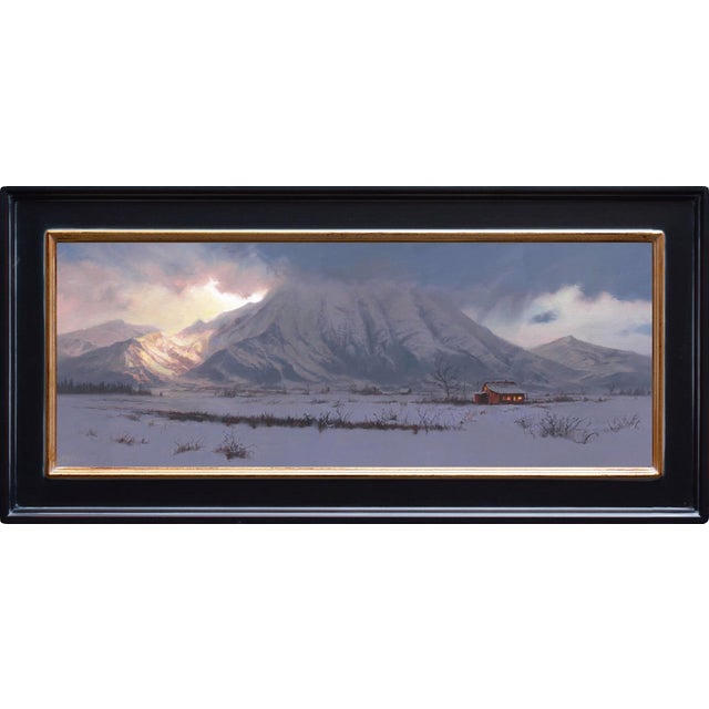 The painting depicts a solitary red cabin nestled in a snow-covered landscape, surrounded by towering mountains shrouded...