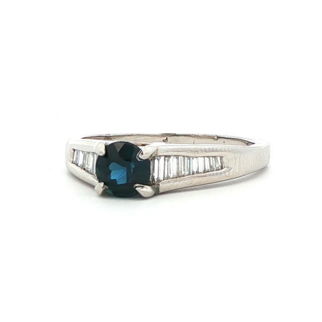 This stunning platinum ring features a gorgeous blue sapphire center stone that is surrounded by a cascade of sparkly...