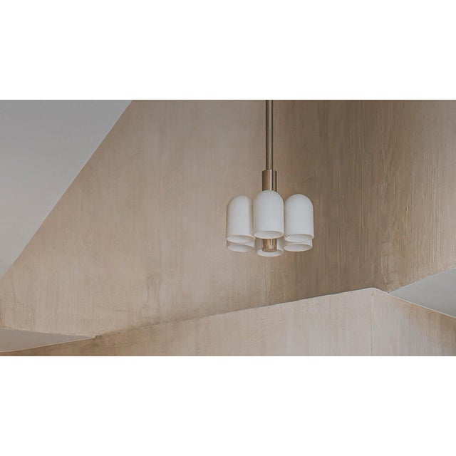 Influenced by the fashions of the future, in large and small scale. A honeycomb structure of six glass shades suggests...
