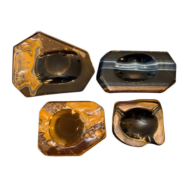 Striking set of four carved natural tiger’s eye stone catchall trays, dating to the mid-20th century, circa 1960s–1970s....